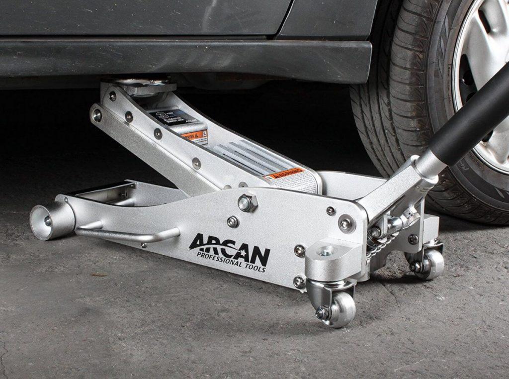 Placing Arcan ALJ3T floor jack under car