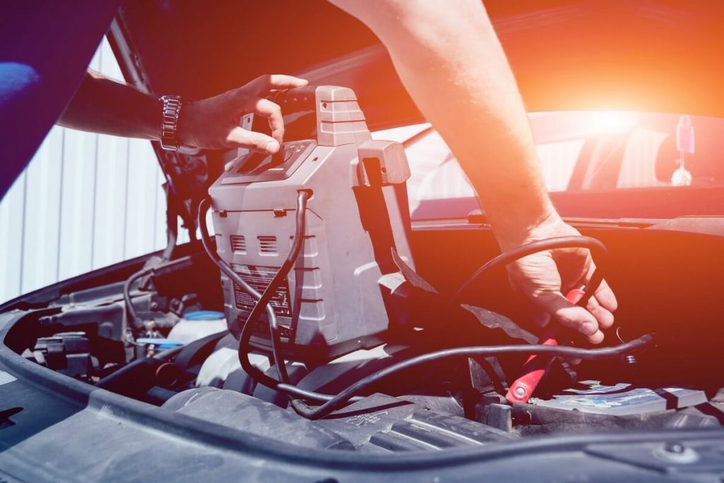 Mechanic using portable jump-starter