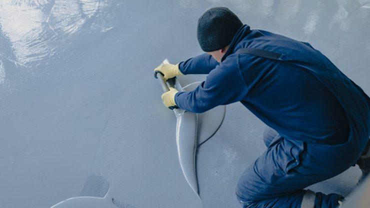 Man coating garage floor