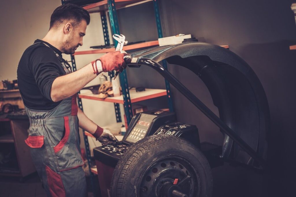 mechanic balancing a wheel