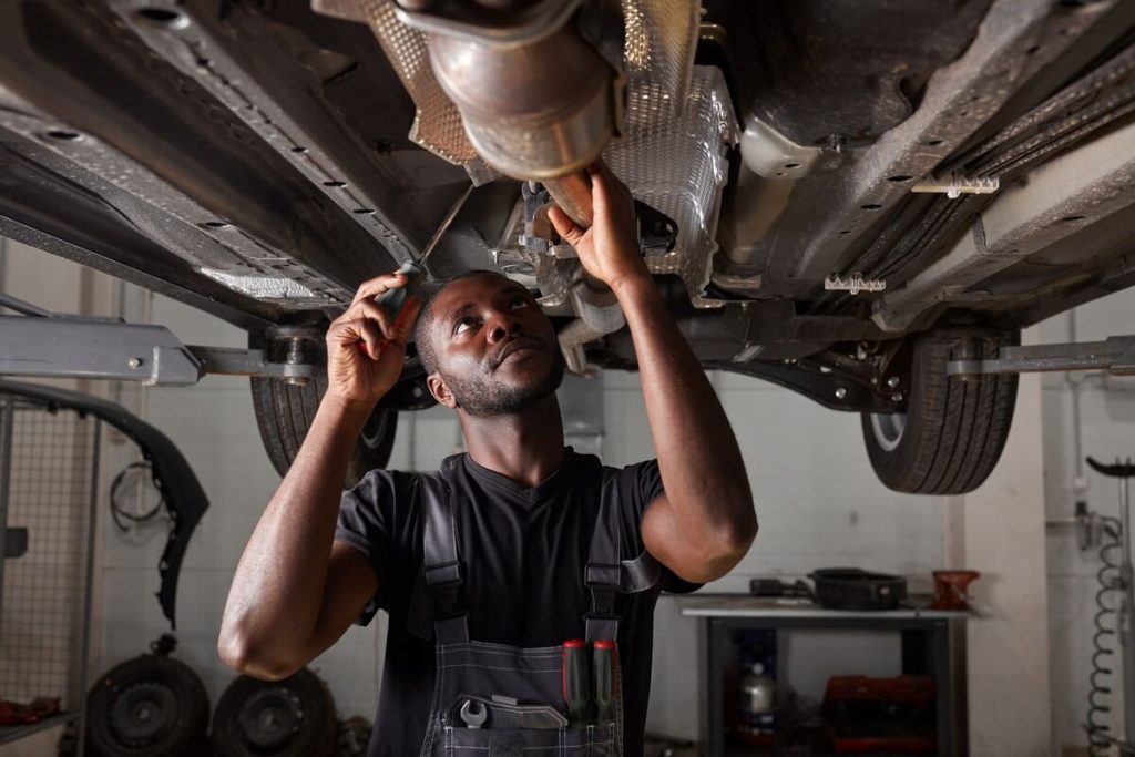 Mechanic working under car lift